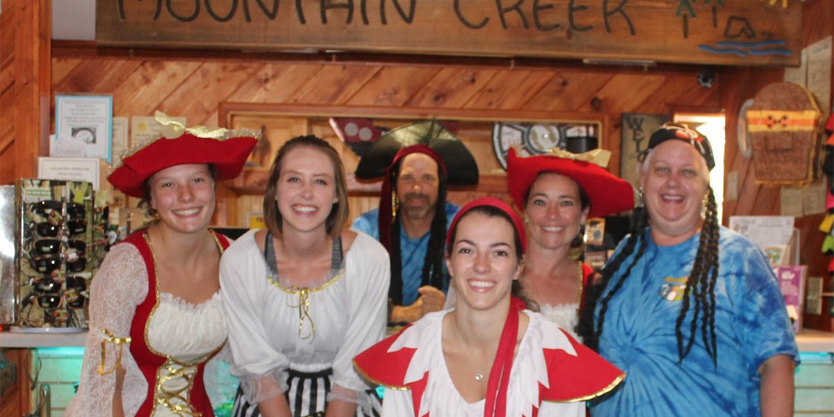 Mountain Creek Campground staff dressed as pirates during a themed camping weekend inside the camp store.